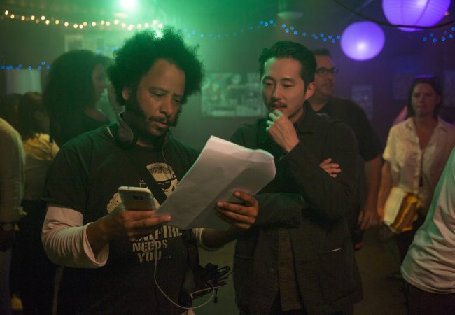 (l to r.) Director Boots Riley and Steven Yeun on the set of SORRY TO BOTHER YOU, an Annapurna Pictures release.