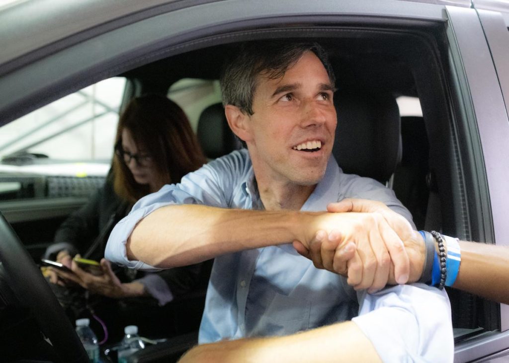 Running with Beto. Beto O'Rourke shakes hands with a potential voter as he departs a campaign event in Houston, TX on November 5, 2018. | Credit: Charlie Gross)