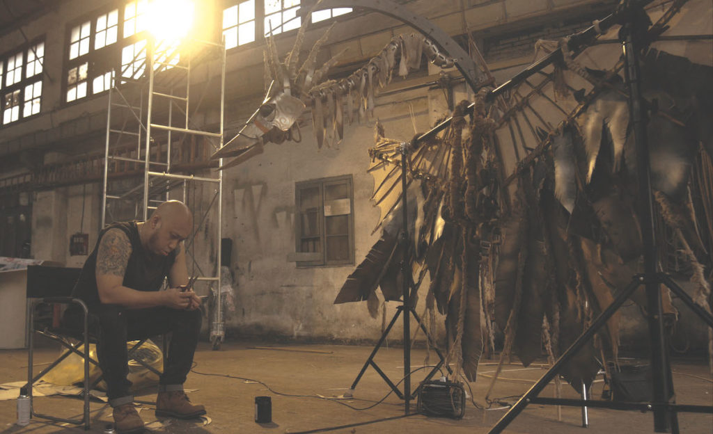 OUR TIME MACHINE. Maleonn working on bird sculpture. Courtesy Maleonn Studio.