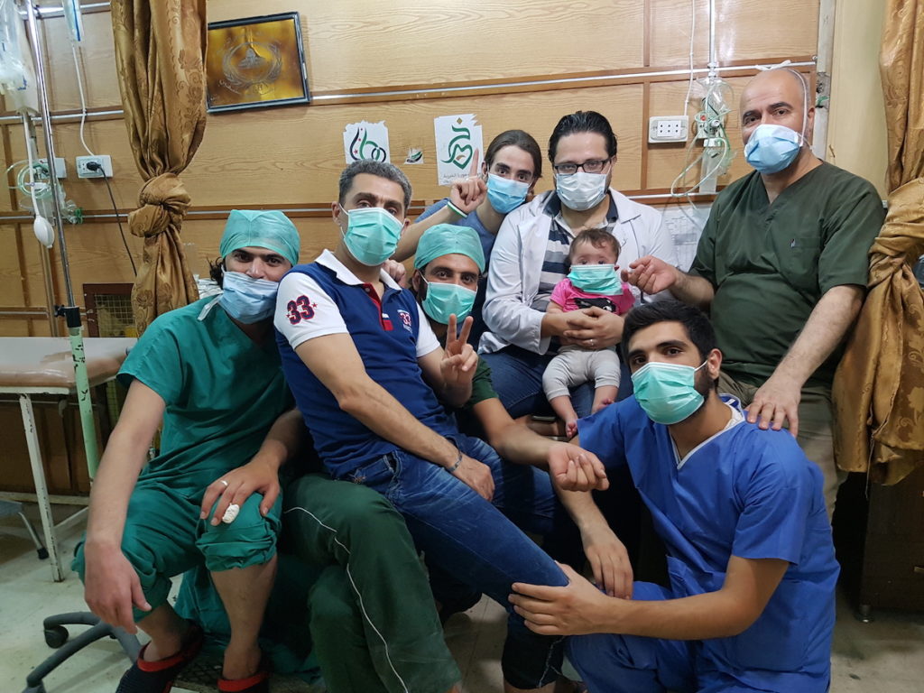 FOR SAMA. Hamza, Sama and the staff of al-Quds hospital, which Hamza set up in 2012 in east Aleppo. Courtesy of Channel 4, Copyright Waad al-Kateab.