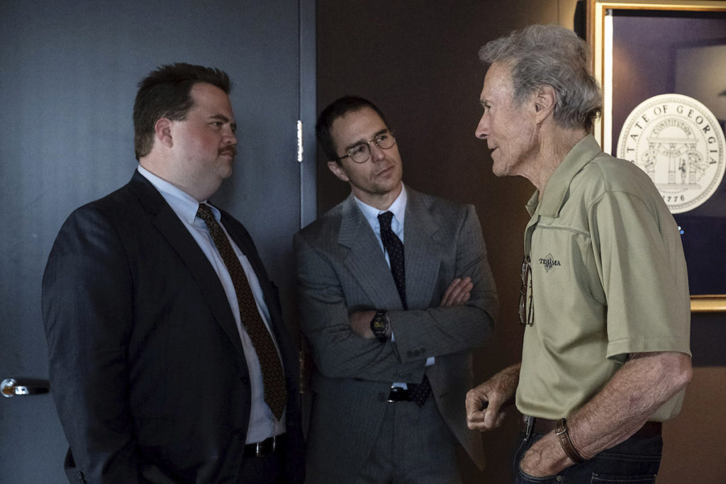 (L-R) PAUL WALTER HAUSER, SAM ROCKWELL and CLINT EASTWOOD on the set of Warner Bros. Pictures’ “RICHARD JEWELL,” a Warner Bros. Pictures release. Photo by Claire Folger