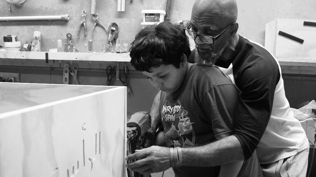 Twelve - year - old Furquan, learning how to build a casket with the help of Hanif, in Two Gods, directed by Zeshawn Ali. Photo credit: Zeshawn Ali