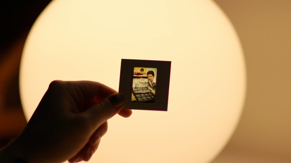 Alison Tavel holds a slide showing her father, Don Tavel, with the Resynator